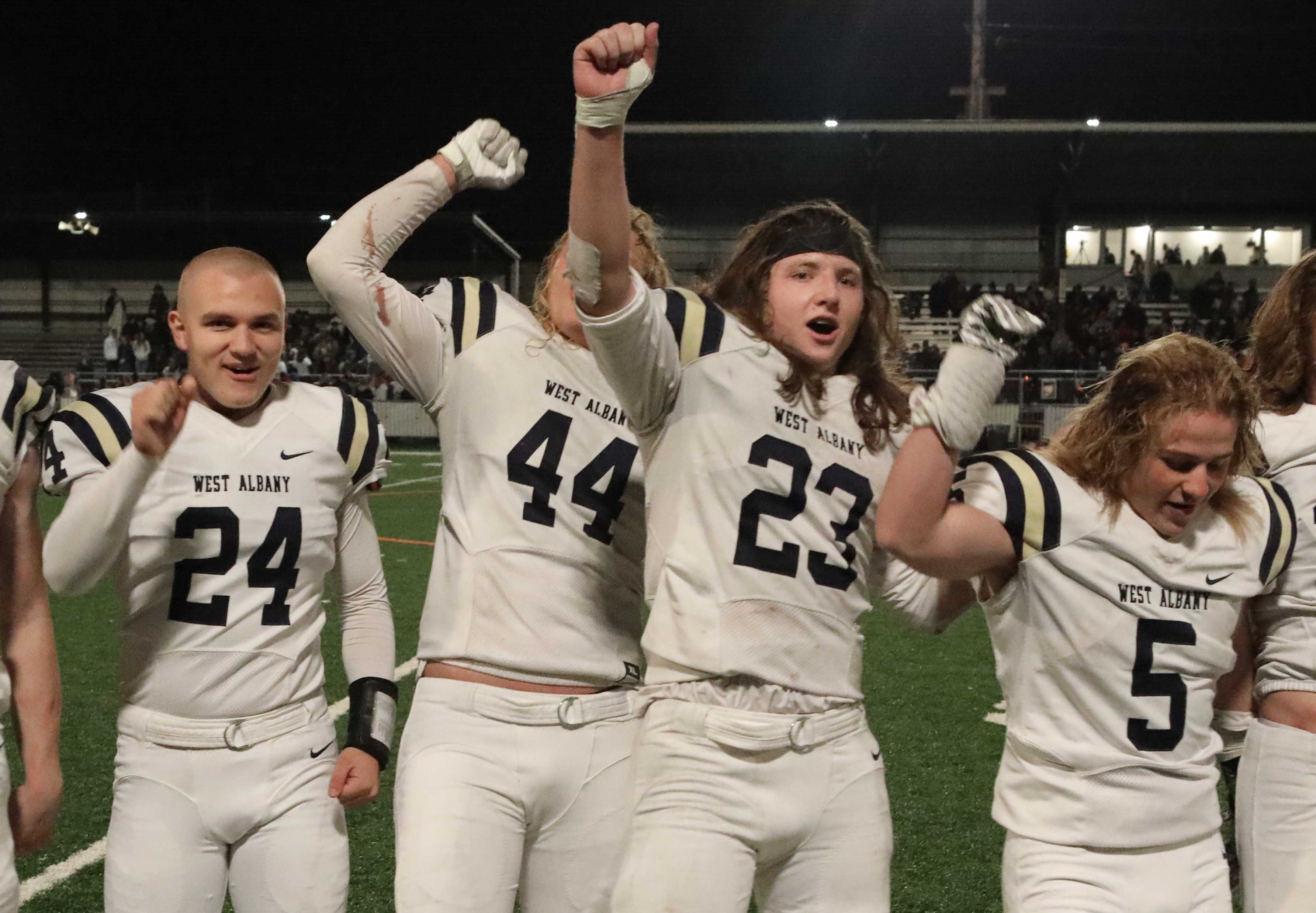 West Albany running back Porter Phillips (23) joins teammates and Bulldog fans in the singing of the alma mater after the win