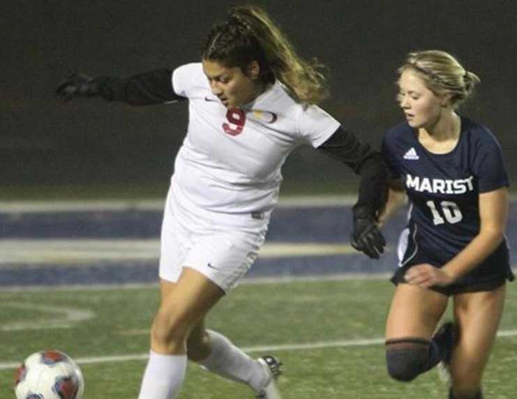 Ontario's Iris Meza (9) battles with Marist Catholic's Whitney Korth (10) on Tuesday. (Photo by Kevin Cave)