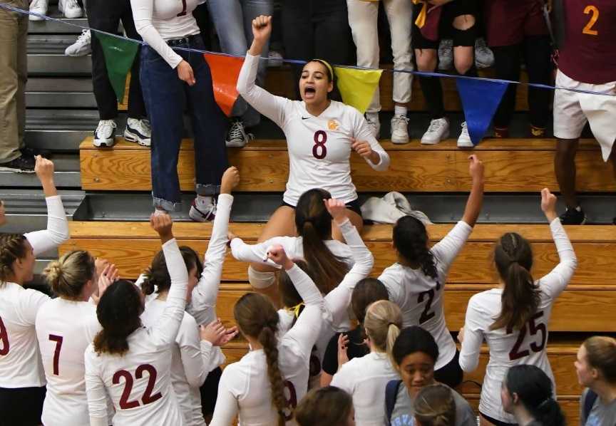 Marianna Payne (8) and Central Catholic celebrate a semifinal win. (Photo by Ed McReynolds)