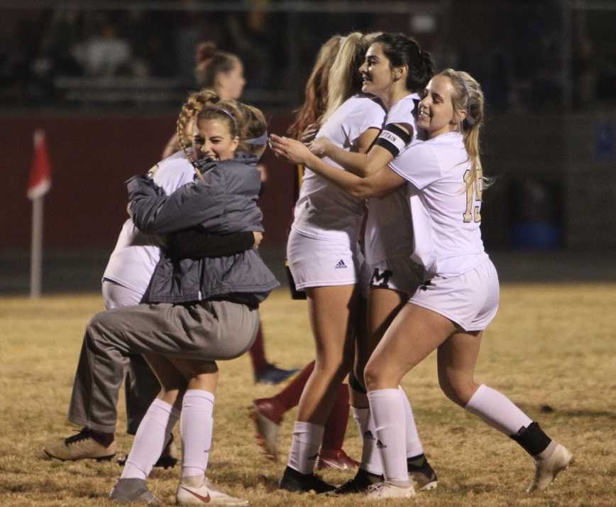 Marist Catholic players celebrate their win over North Valley. (Photo by Kevin Cave)