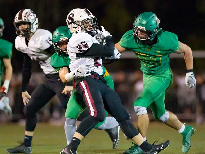 Sherwood's Brody Stevens fights for yards against West Linn on Oct. 4. (Photo by Brad Cantor)