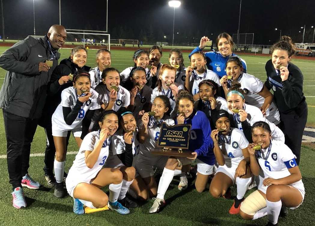 Woodburn's girls pose with their first state championship trophy Saturday. (Photo by Kyle Pinnell)