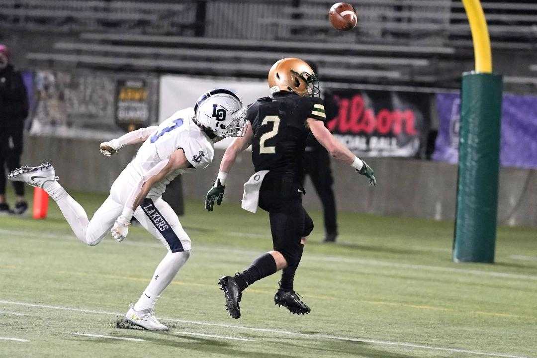 Lake Oswego's Joe Hutson (3) knocks the ball away from Jesuit's Kade Wisher in the fourth quarter Friday. (Photo by Jon Olson)