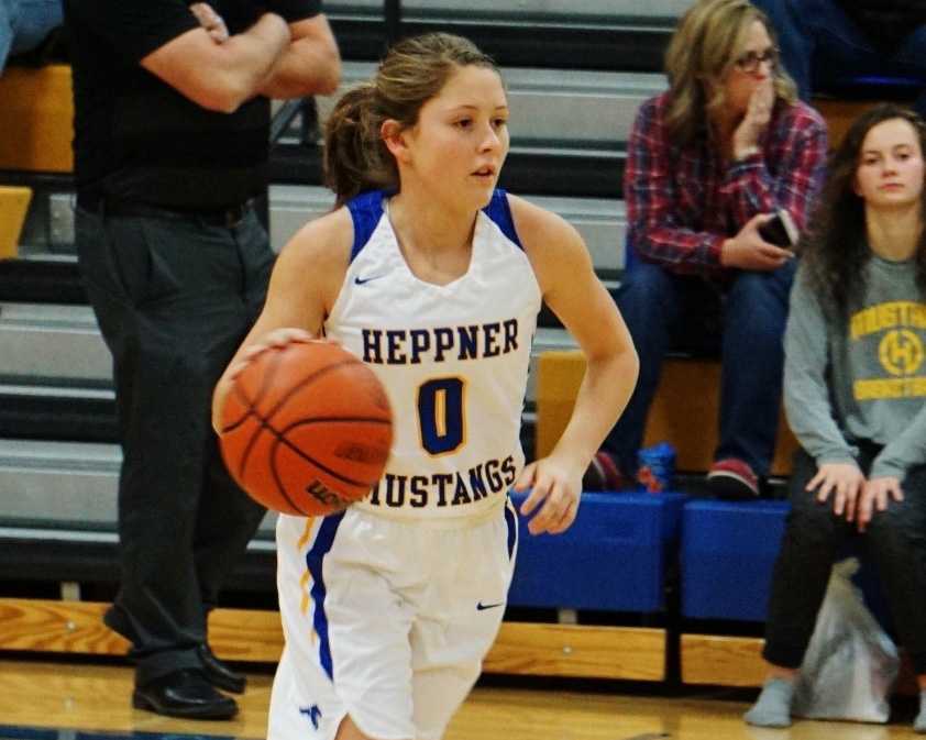 Madelyn Nichols brings the ball upcourt for the Heppner Mustangs