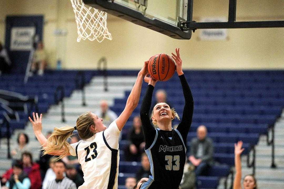 Canby's Nicole Mickelson (23) blocks Mountainside's Cameron Brink (33) on Tuesday night. (Photo by Jon Olson)