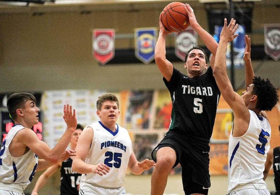 Tigard's Drew Carter rises over Western Christian's Payton Richardson (5) and Darrin Campbell (25). (Photo by Jon Olson)