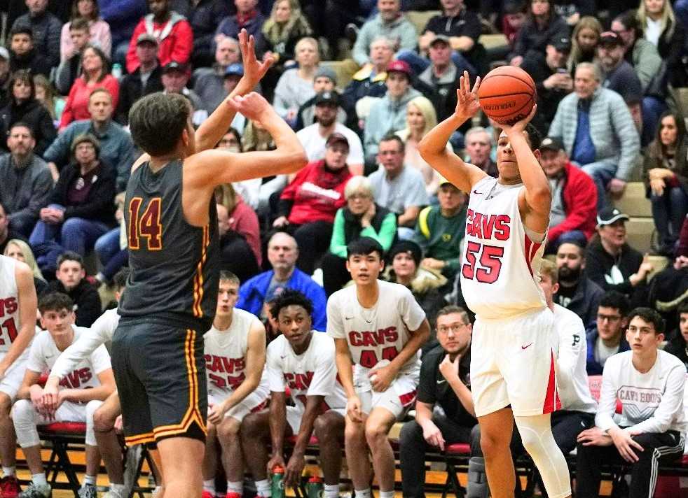 Clackamas' Izzy Baker (55) shoots over Central Catholic's Luke Johnson on Friday. (Photo by Jon Olson)