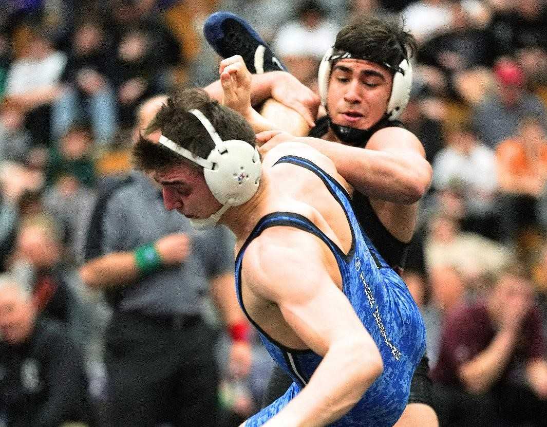Crescent Valley's Santos Cantu (right) works against La Grande's Christopher Woodworth on Saturday night. (Photo by Jon Olson)
