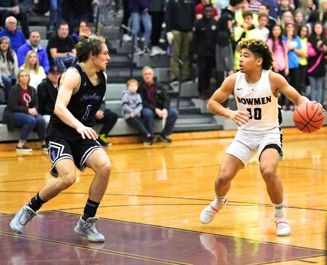 Sherwood's Jamison Guerra (10) works against the defense of Newberg's Jake Gaunt (1). (Photo by Jon Olson)