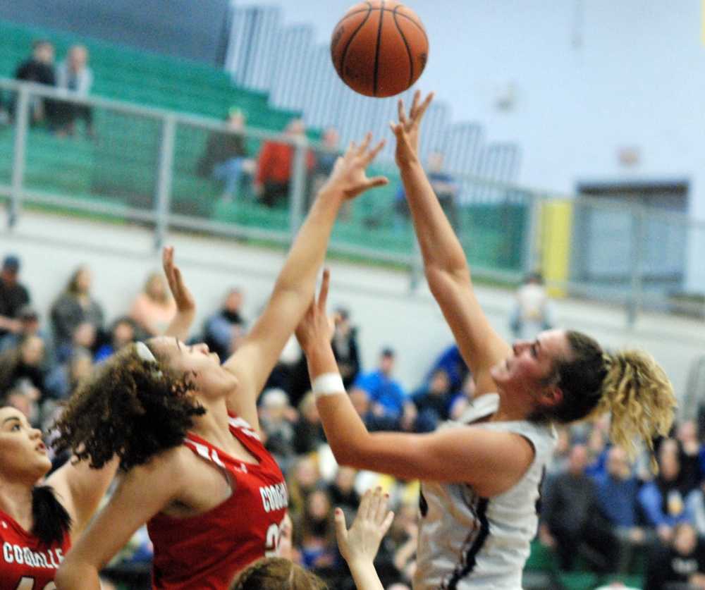 Kennedy forward Sophia Carley puts up a shot over Coquille star Morgan Baird. The Kennedy star scored a game-high 23 points.