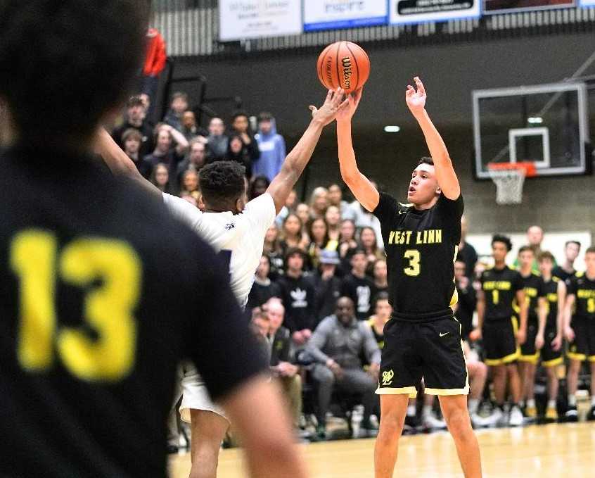 West Linn's Jackson Shelstad hits a long three-pointer at the first-quarter buzzer at Mountainside. (Photo by Jon Olson)