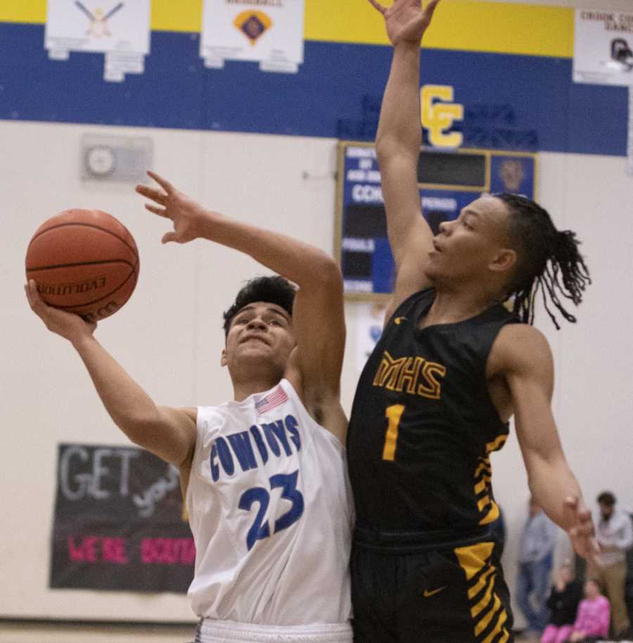 Crook County's Kevin Sanchez works against Milwaukie's Keshawn Myles in Saturday's win. Photo by Lon Austin, Central Oregonian