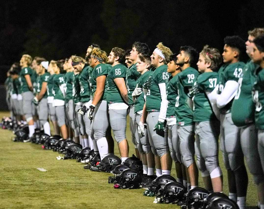 Tigard football players prepare to take on district rival Tualatin last season. (Photo by Jon Olson)