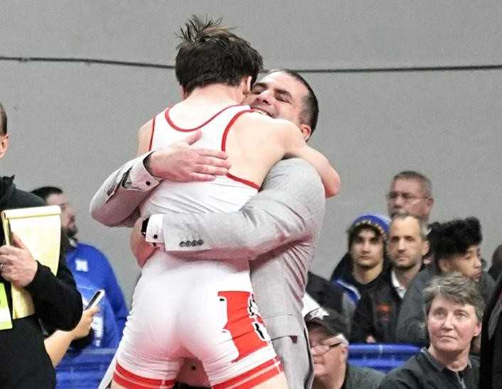 Bo Hampton celebrates with Reedsport 120-pound champion Elijah Carson at the state tournament. (Photo by Jon Olson)