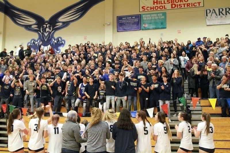 Canby's players celebrate their comeback win with the overflow student section