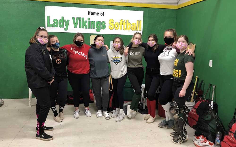 The Colton softball team poses in the new hitting facility made possible by community parents and volunteers