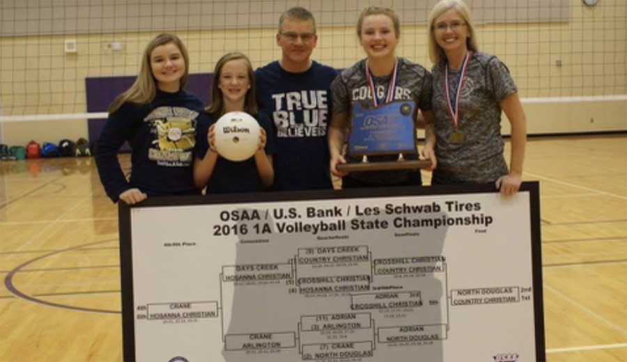 From left, Courtney, Audra, Mike McGrath, Meghan and Janin McGrath show off one of four brackets the Cougars put in their gym.