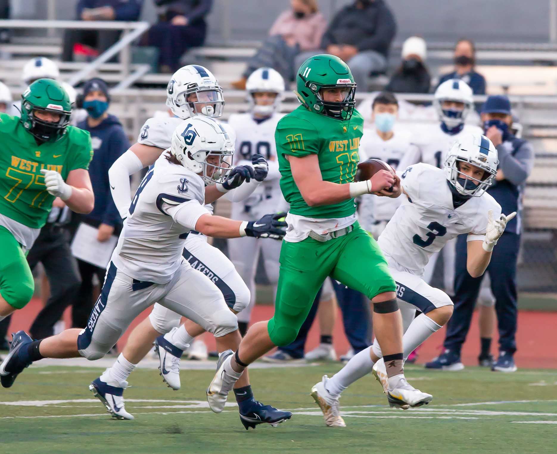 West Linn's Kaanan Huffman outruns Lake Oswego defenders on a 29-yard touchdown catch. (Photo by Brad Cantor)
