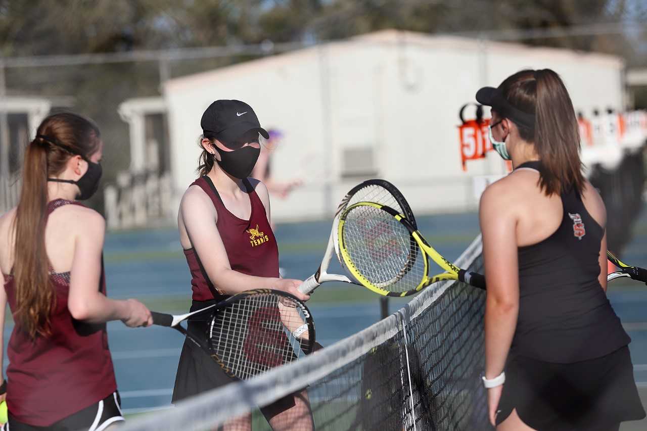 Crescent Valley (left) and Sprague (right) girls doubles teams meet in a match this month. (Courtesy Crescent Valley HS)
