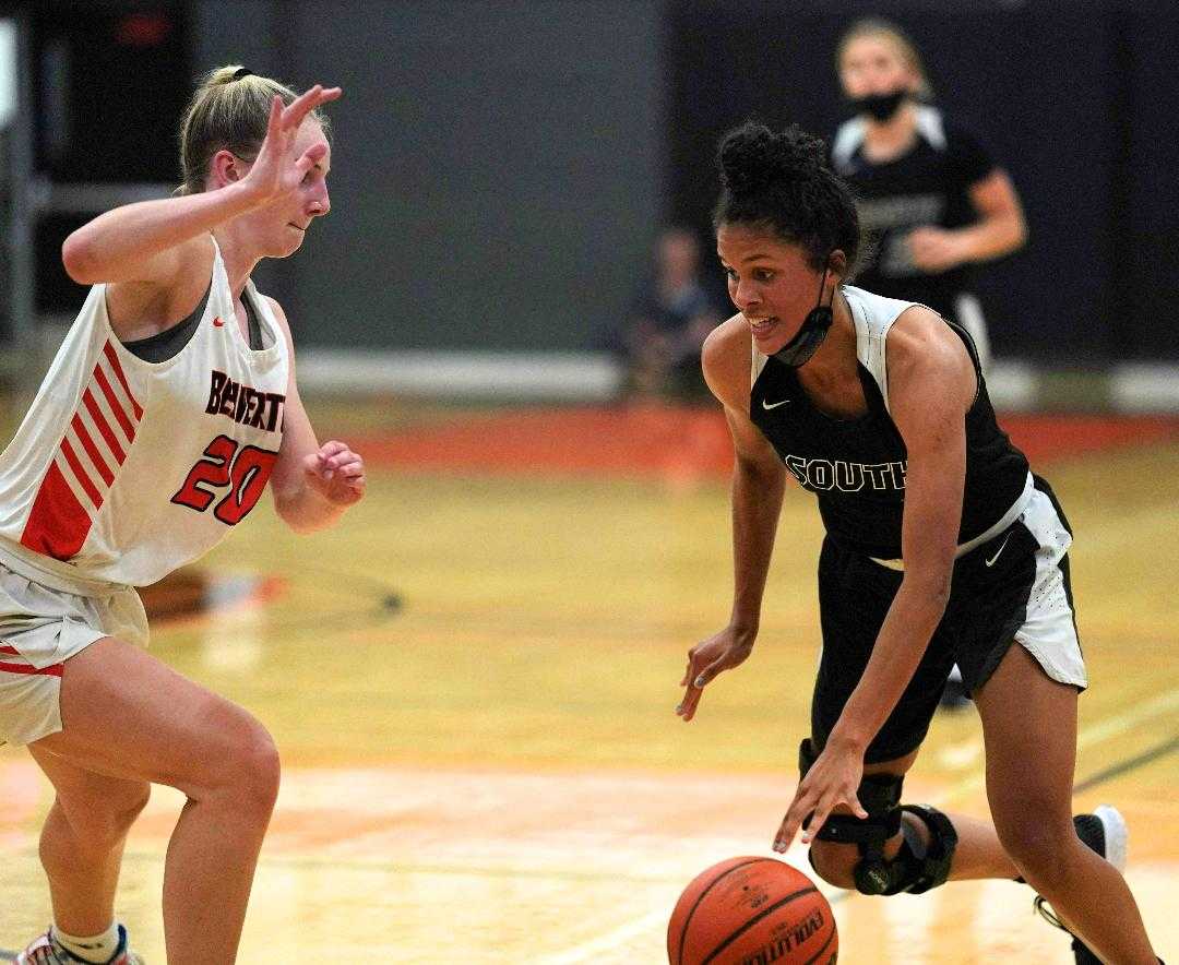 South Medford's Donovyn Hunter (right) drives against Beaverton's Lainey Spear on Wednesday. (Photo by Jon Olson)