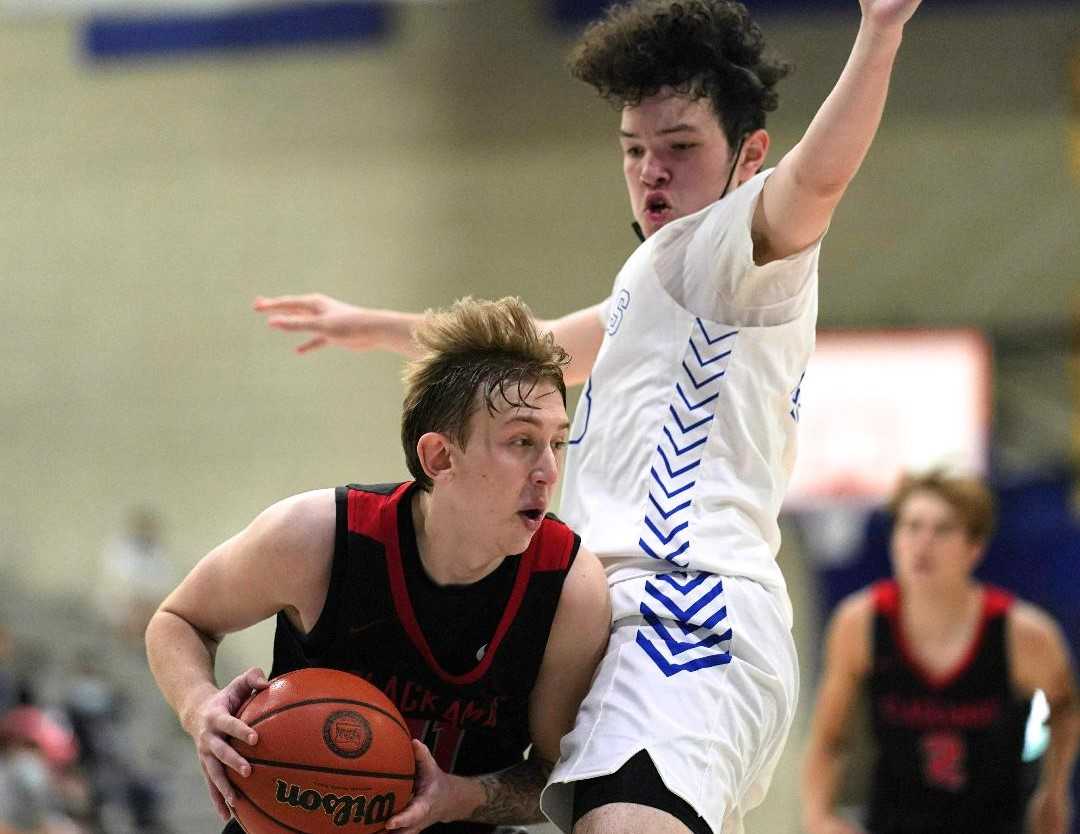 Clackamas' Damon Erickson (left) works against the defense of Gresham's Ulises Gutierrez on Saturday. (Photo by Jon Olson)