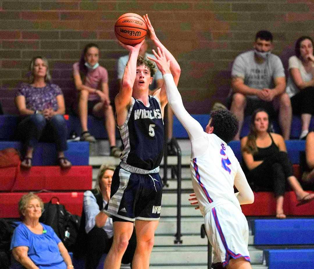 Wilsonville senior wing Riley Scanlan shoots over La Salle Prep sophomore Nick Robertson on Friday. (Photo by Jon Olson)