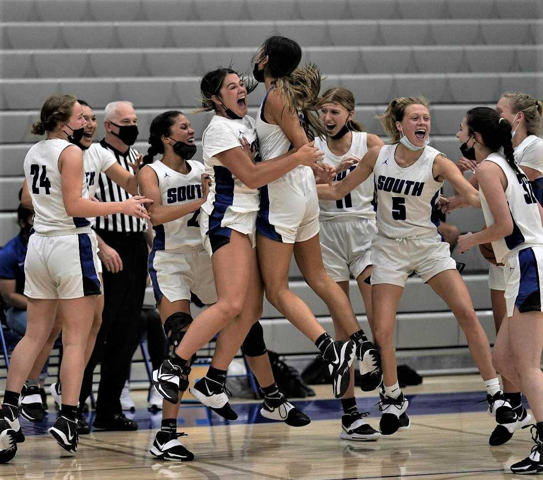 South Medford players celebrate beating Sheldon in the Maroon bracket final at Grant on Thursday. (Photo by Jon Olson)