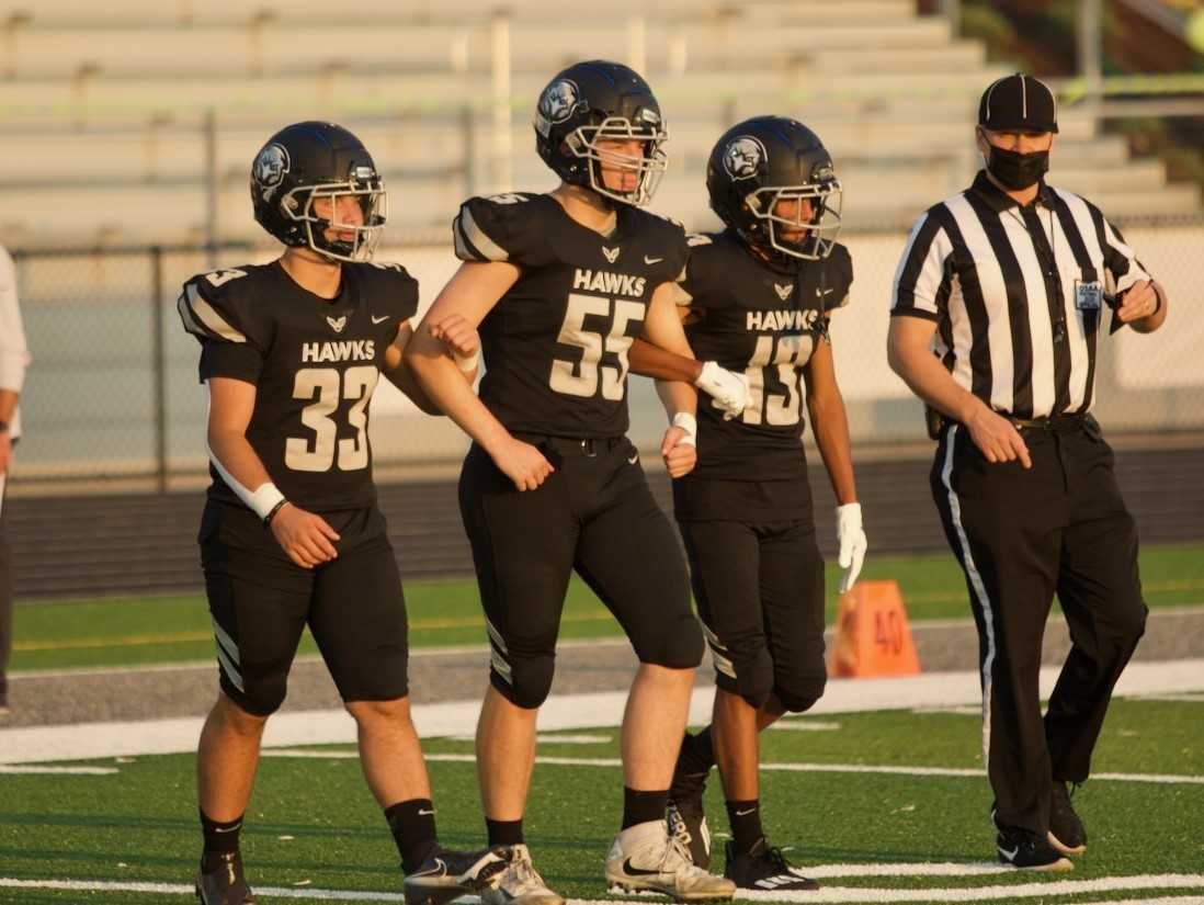 Nelson's Alex Leontyuk (33), Nolan Allen (55) and Reid Gray (13) prepare to meet Barlow. (Photo by Noah Peterson)