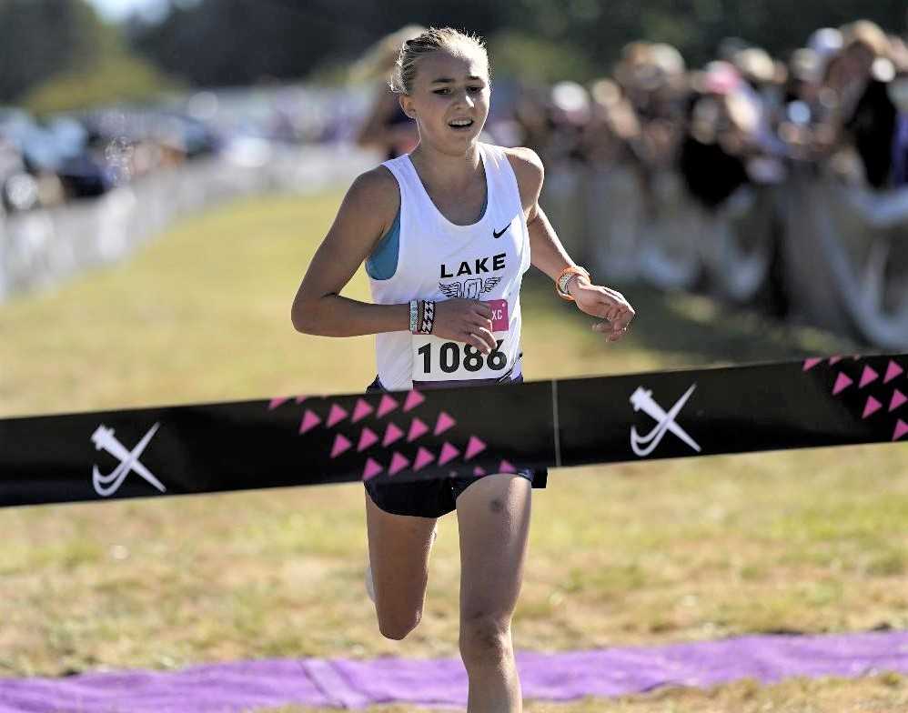 Lake Oswego's Kate Peters crosses the finish line in the Danner Championship race at Blue Lake. (Photo by Jon Olson)