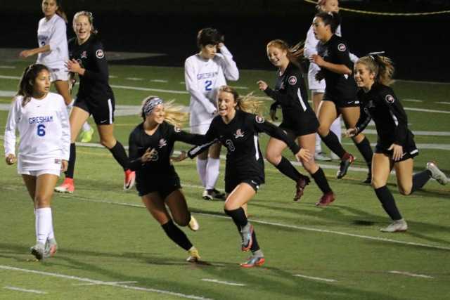 Clackamas' Peyton Fendrich (3) celebrates a goal with Maile McCormick (6).in an 11-0 win over Gresham.