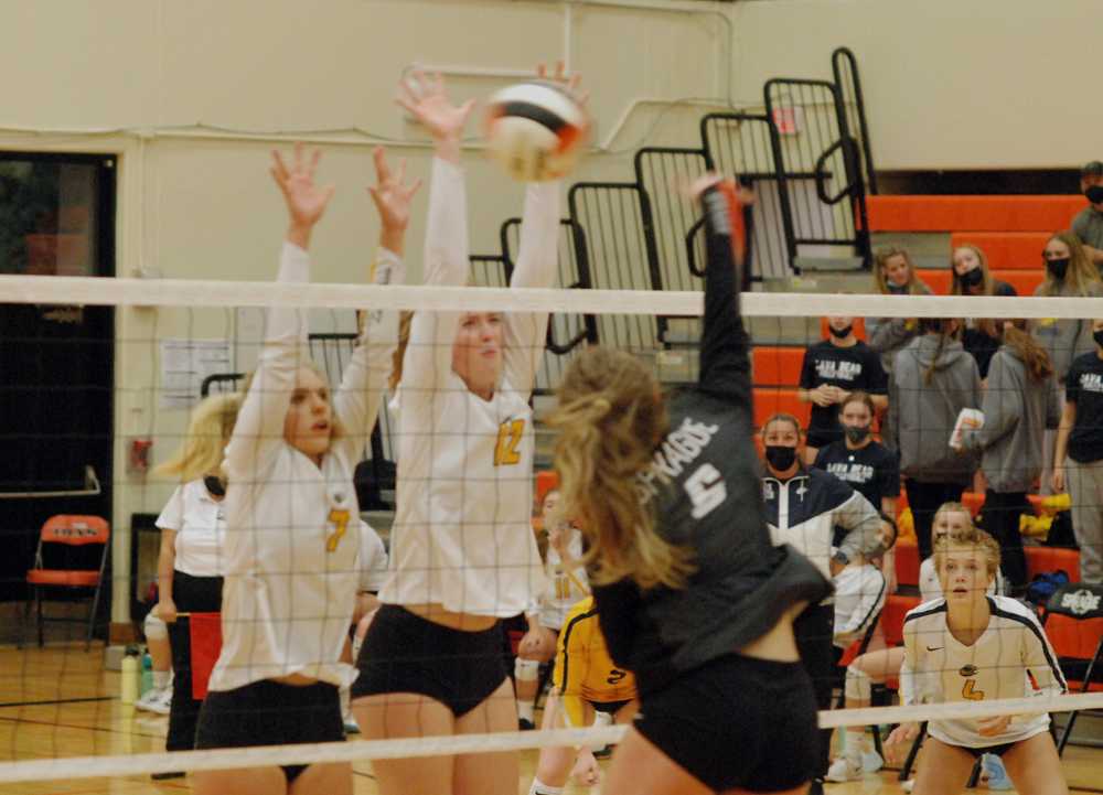 Bend middle Marley Hardgrave (12) teams with Taylor Clark to slow Sidney Friesen's attack for Sprague