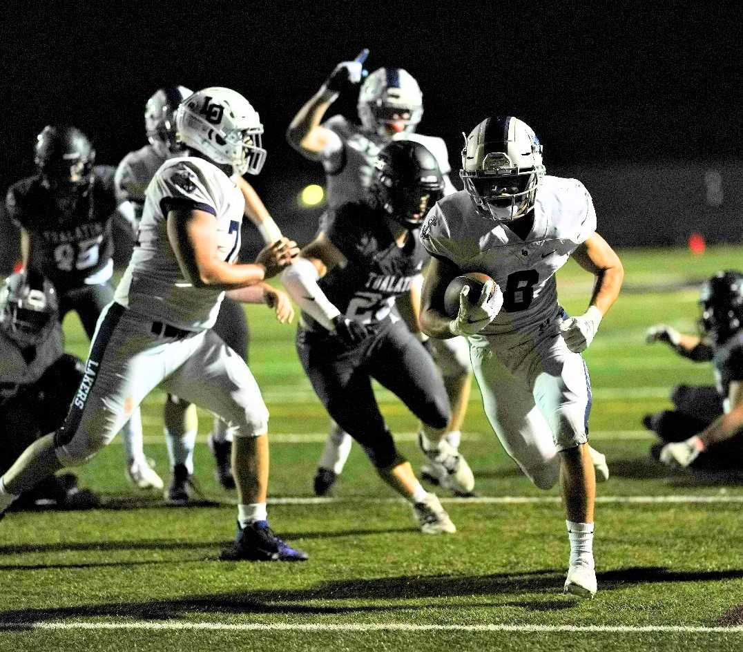 Lake Oswego's Gabe Olvera rushed for 100 yards and two touchdowns in Friday's 35-26 win at Tualatin. (Photo by Jon Olson)