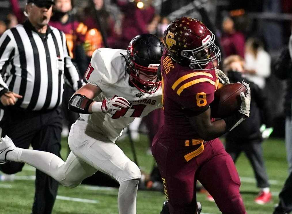 Central Catholic's Ellis Bynum (8) evades Clackamas' Brody Crowley on Friday night at Hillsboro Stadium. (Photo by Jon Olson)