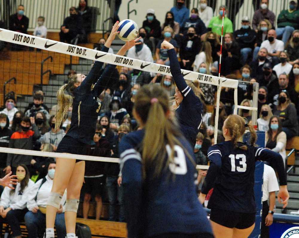 West Albany senior OH Hailey Heider clamps Wilsonville setter Makenna Wiepert for a solo stuff in a key moment in Game 3