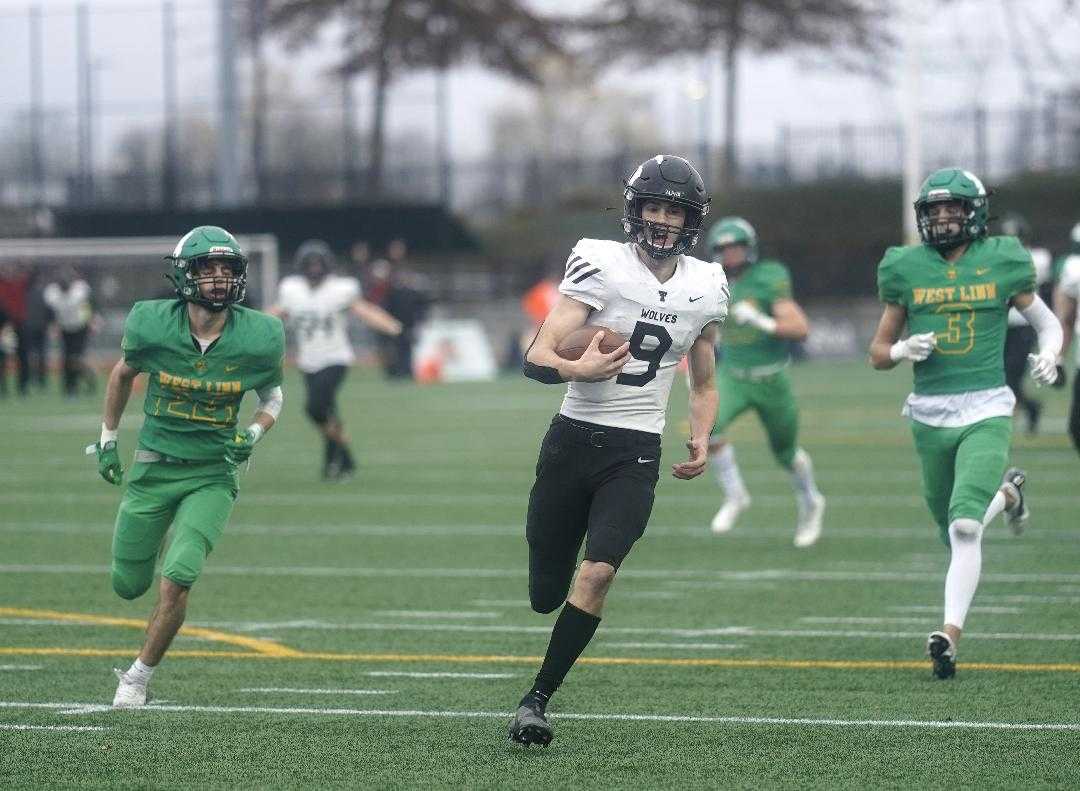 Tualatin's Jack Wagner runs for a 53-yard touchdown in the second half of Friday's win over West Linn. (Photo by Jon Olson)
