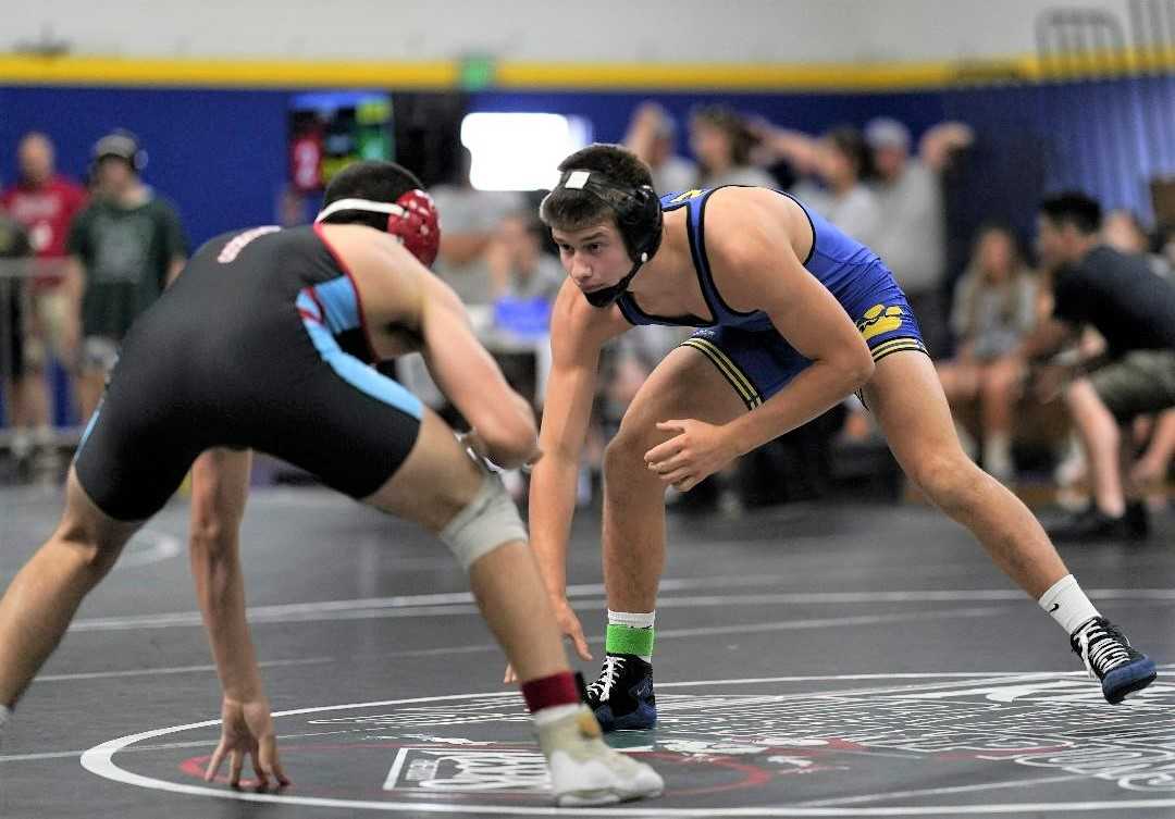 Newberg's Charlie Evans (right) finished first at 152 pounds in the 6A culminating week tournament. (Photo by Jon Olson)