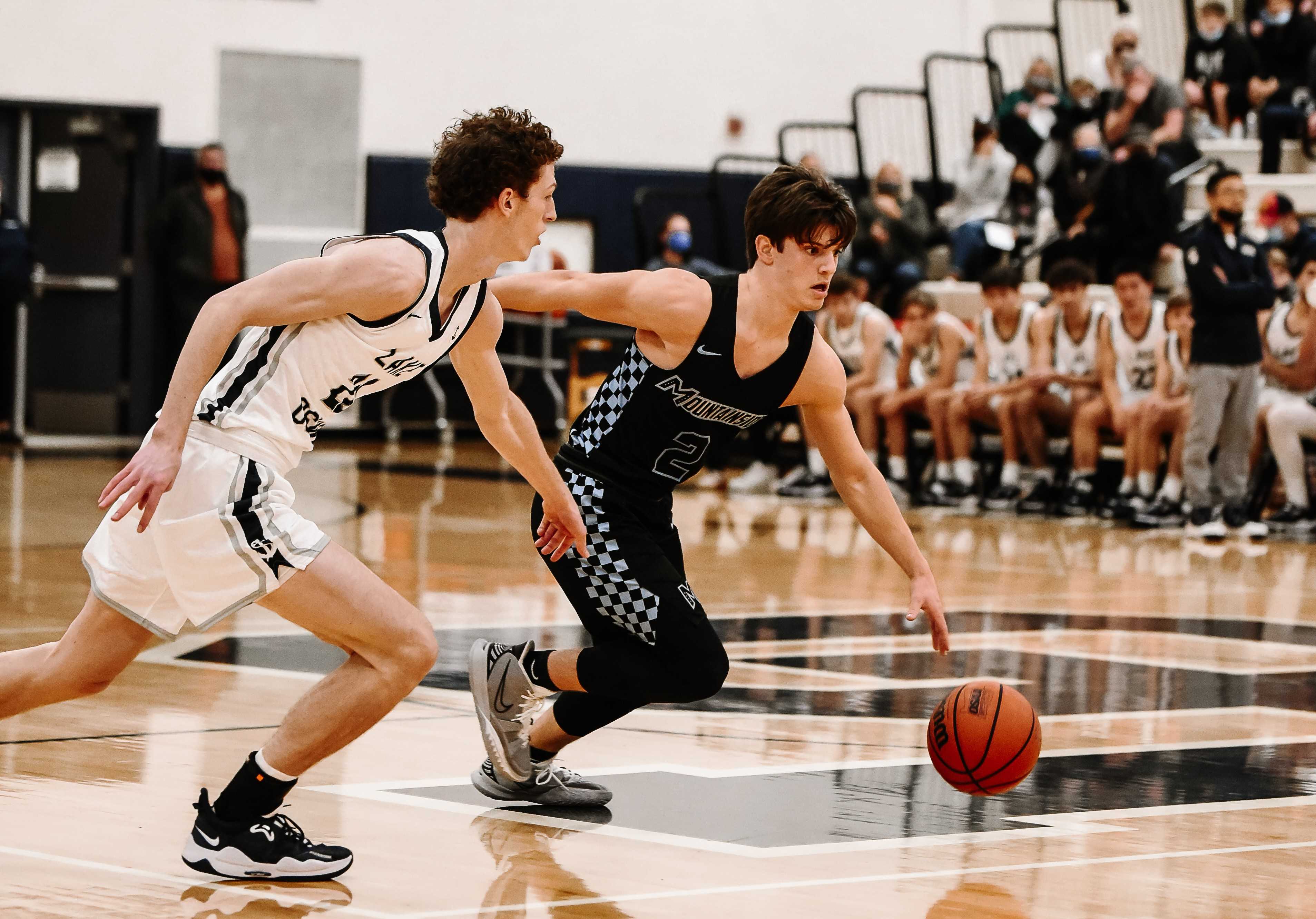 Mountainside's Dimitri Cohen drives past Lake Oswego's Christian Rowell on Tuesday night. (Photo by Fanta Mithmeuangneua)