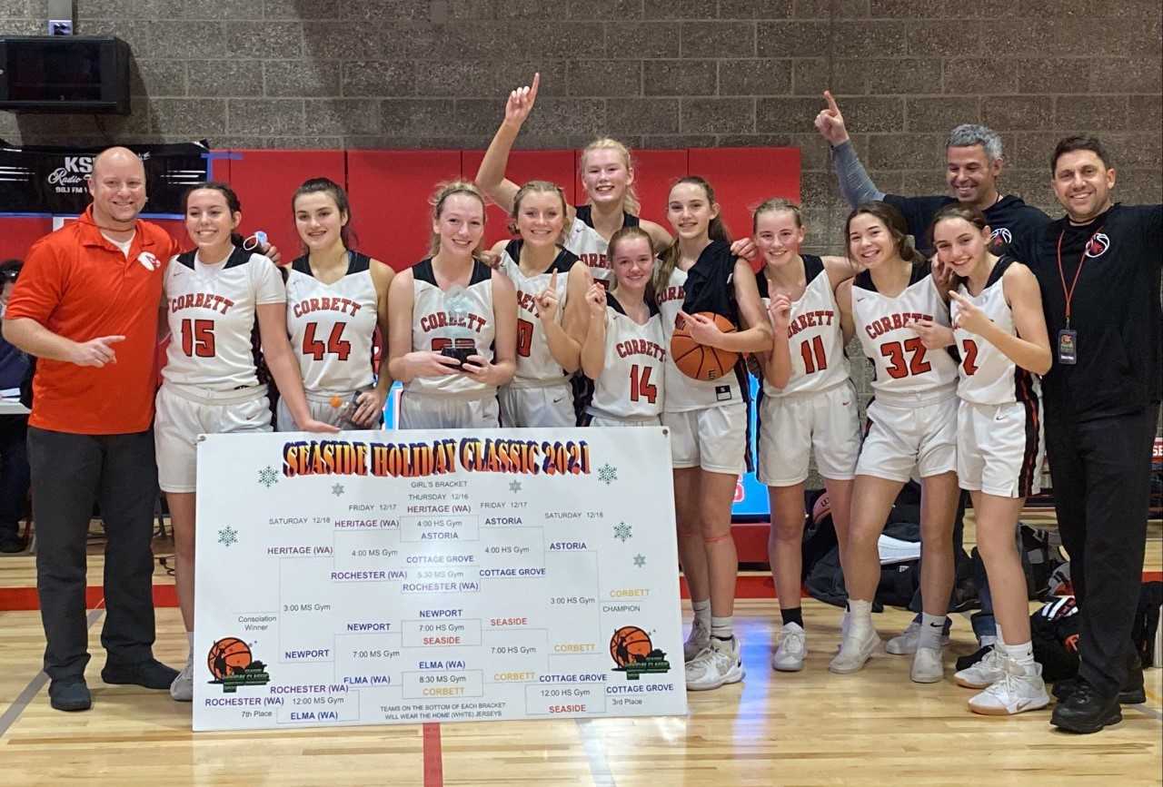 Coach Bill Schimel (right) and the Cardinals celebrate after beating Astoria in the final of the Seaside Holiday Classic.