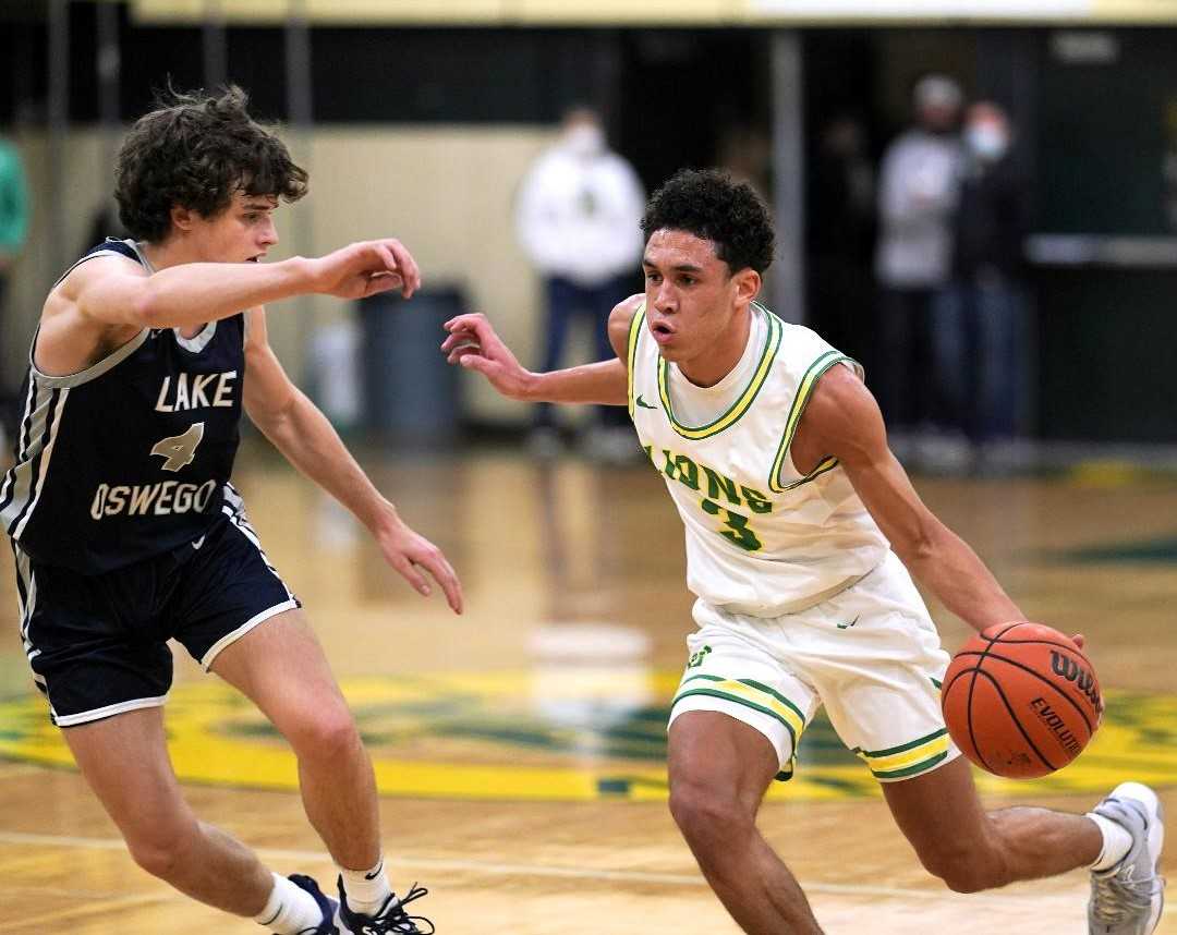 West Linn's Jackson Shelstad (3) works against pressure from Lake Oswego's Luke Brauner (4). (Photo by Jon Olson)