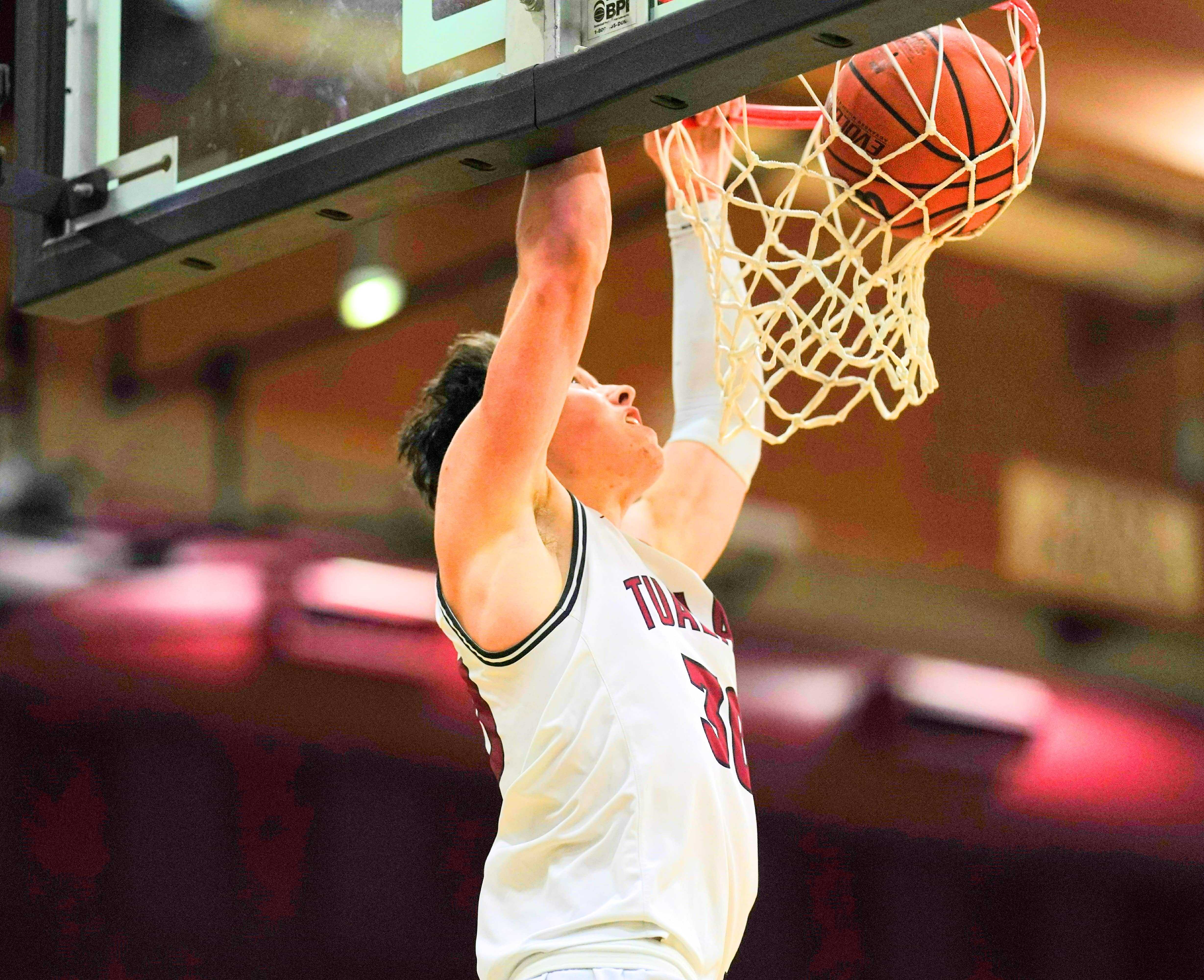 Tualatin's Kellen Hale goes up for a breakaway dunk in the final minutes of Friday's win over West Linn. (Photo by Jon Olson)