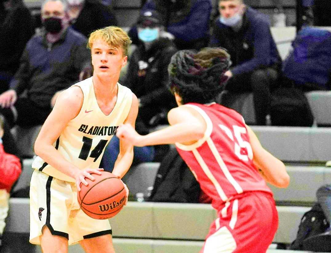 Gladstone's Cohen Daves (14) looks to attack against Corbett's Cannon Davis on Tuesday night. (Photo by Jon Olson)