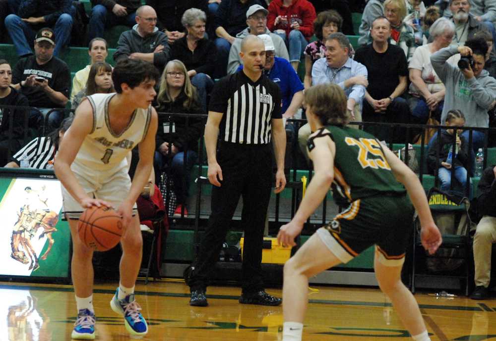 Salem Academy senior guard John Pass looks for an opening under the watchful eye of Regis sophomore Noah Koenig