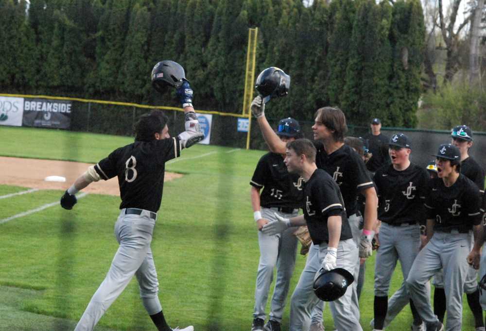 Levi Jones (8) gets a greeting, 'Sader style, after slamming a first-inning homer