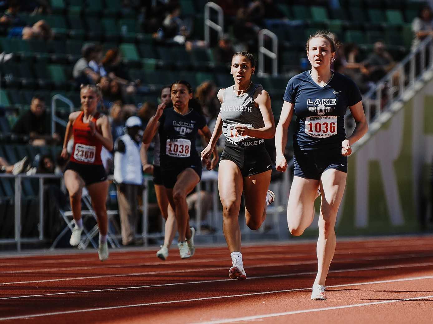 Lake Oswego's Mia Brahe-Pedersen holds off Roosevelt's Lily Jones in the 200 Saturday. (Photo by Fanta Mithmeuangneua)