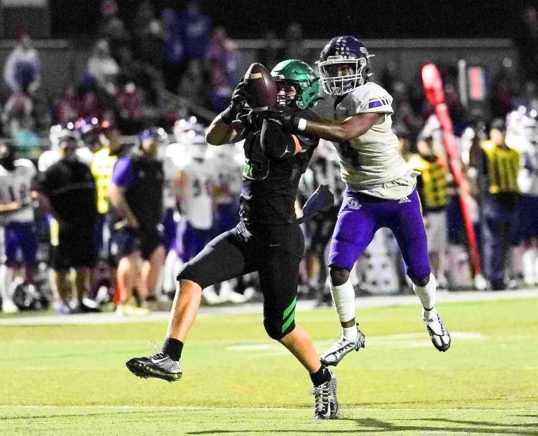 West Linn's Mark Hamper holds off Lake Stevens' Cassidy Bolong-Banks for a touchdown catch Friday night. (Photo by Jon Olson)