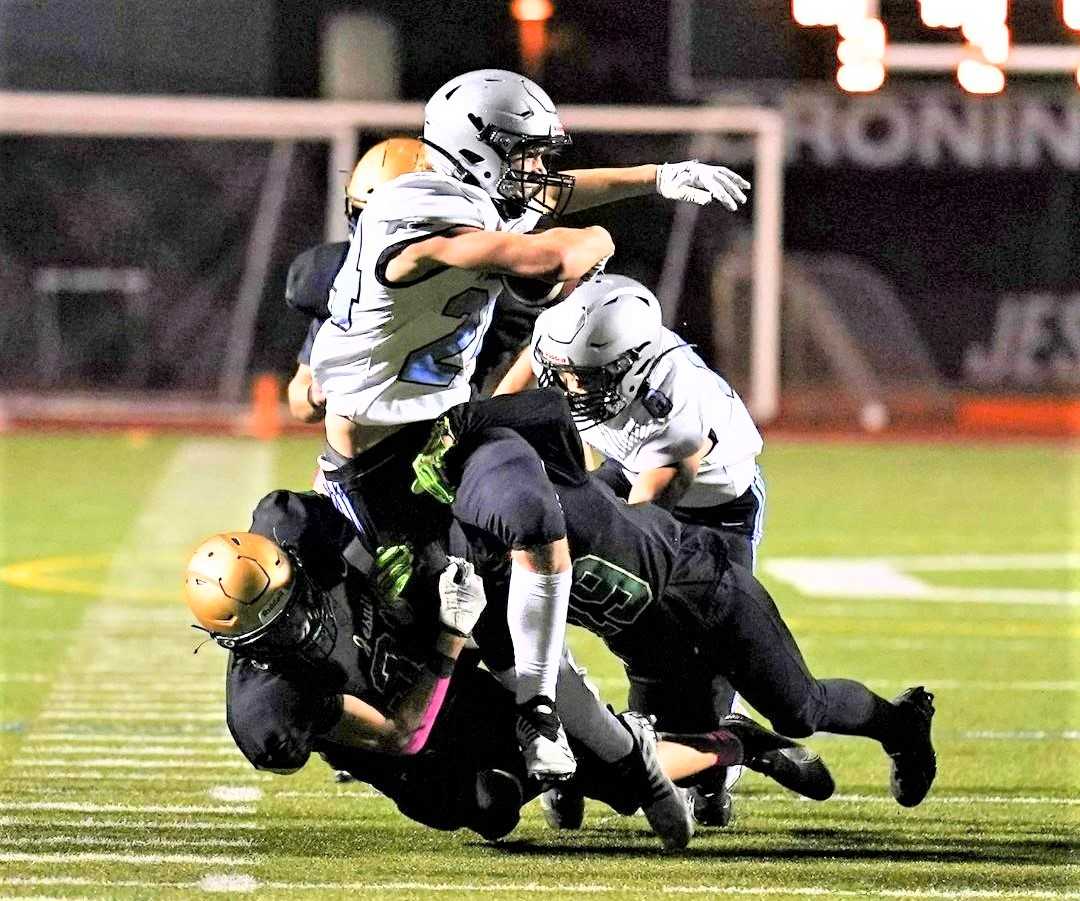 Mountainside's Sam Vyhlidal fights for yards against Jesuit, which held the Mavericks to 78 total yards. (Photo by Jon Olson)