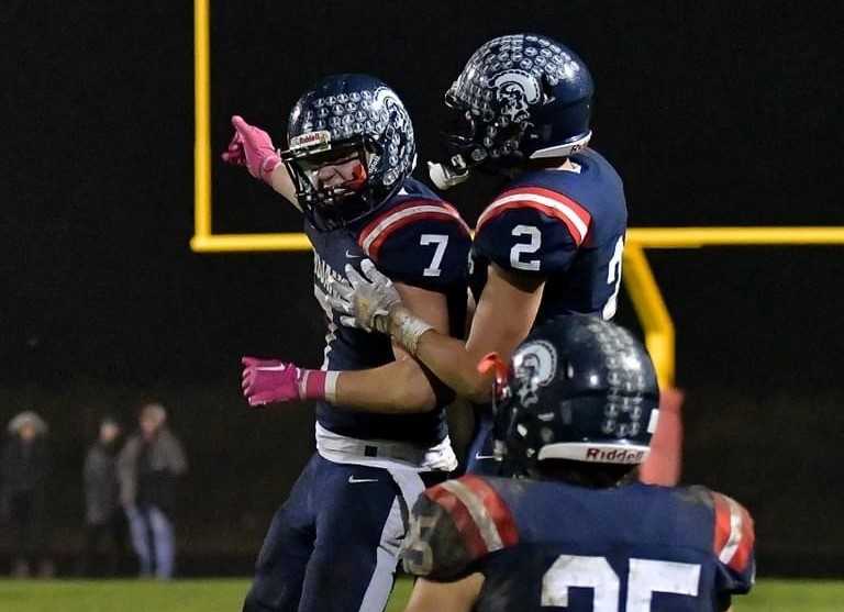 Kennedy's Luke Beyer (7) and Ethan Kleinschmidt (2) celebrate the winning touchdown pass Friday. (Photo by Andre Panse)