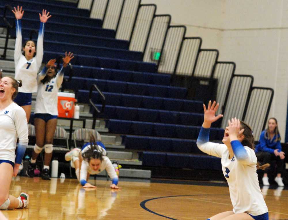 Addie Emerson (far left), Jojo Christiansen (far right) and the Valley Catholic bench erupt after sweeping Burns for the state