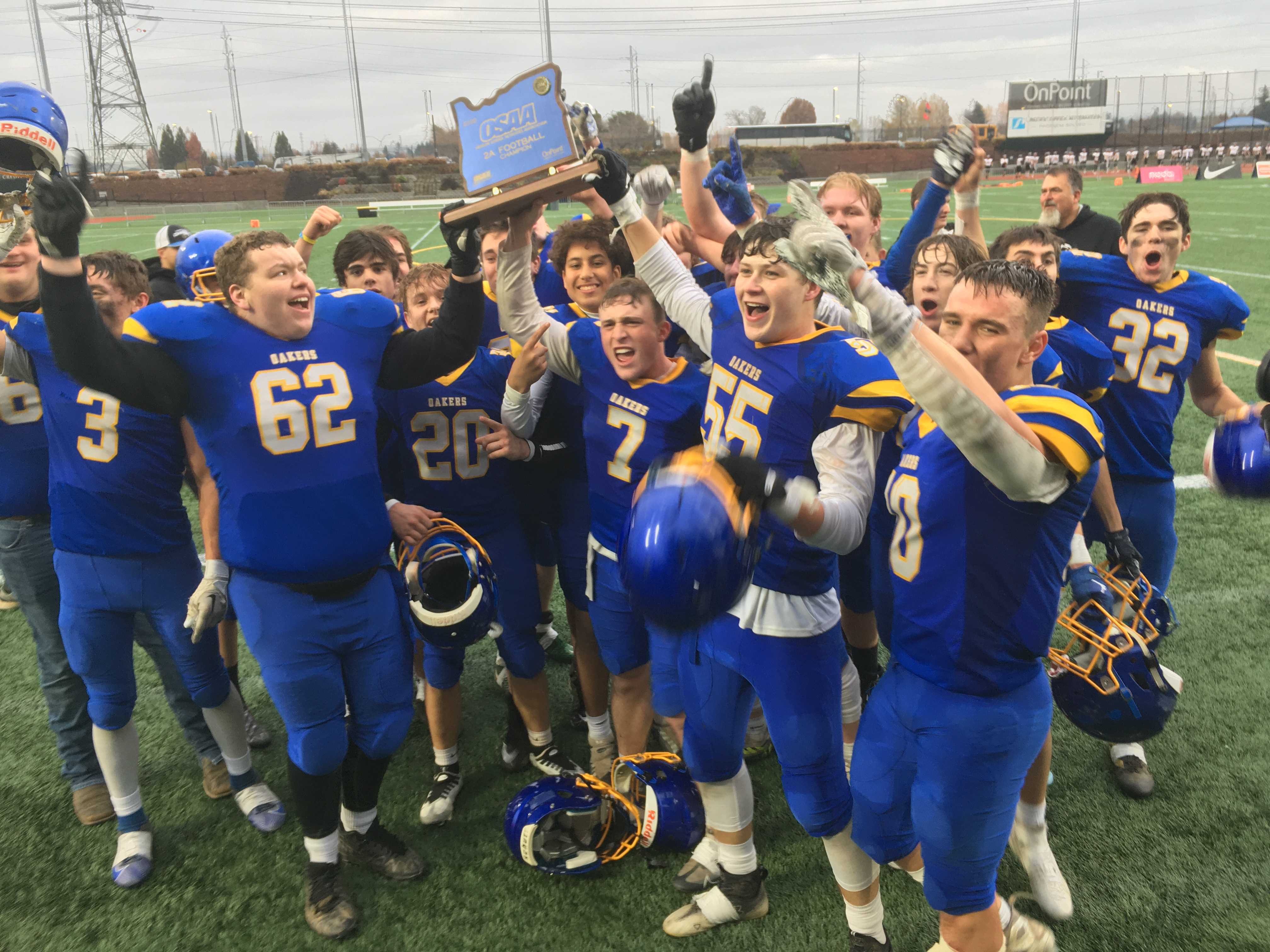 Oakland players hold up their blue trophy after winning their first state championship in 10 years Saturday.