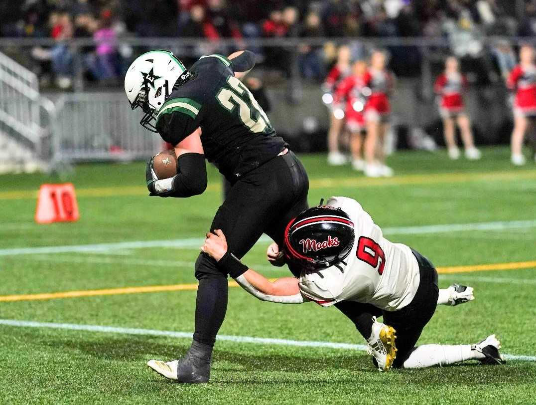 Estacada's James Durand (22) tries to shake off Tillamook's Tyler Moncrief (9) on Saturday night. (Photo by Jon Olson)